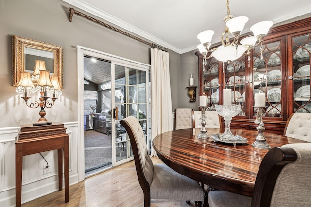 314 W 6th St, Columbia, TN 38401 - dining area with a chandelier, wood finished floors, ornamental molding, and wainscoting