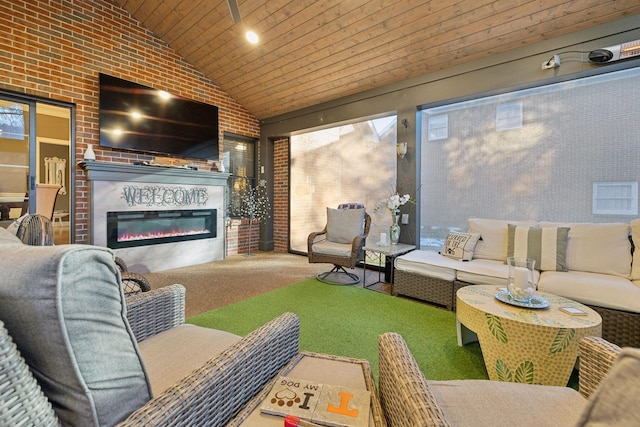 314 W 6th St, Columbia, TN 38401 - living room featuring carpet flooring, wooden ceiling, plenty of natural light, a glass covered fireplace, and brick wall