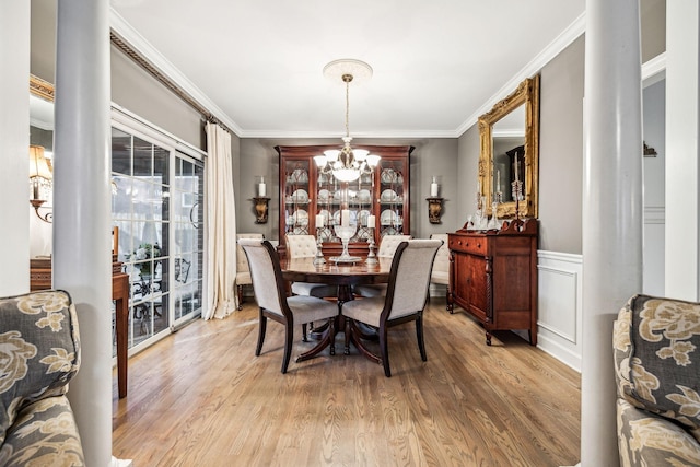 314 W 6th St, Columbia, TN 38401 - dining area featuring a chandelier, ornamental molding, light wood-type flooring, wainscoting, and ornate columns