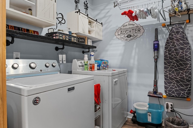 4200 Happy Valley Rd, Flintstone, GA 30725 - washroom with washing machine and clothes dryer, cabinet space, and wood finished floors