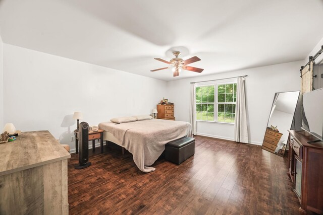 516 Delacy Dr, Fairview, TN 37062 - bedroom with a barn door, dark wood-type flooring, and a ceiling fan