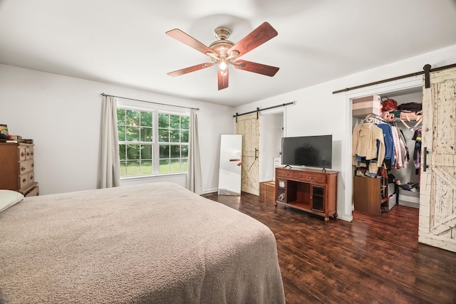 516 Delacy Dr, Fairview, TN 37062 - bedroom with a barn door, wood finished floors, a walk in closet, and a ceiling fan