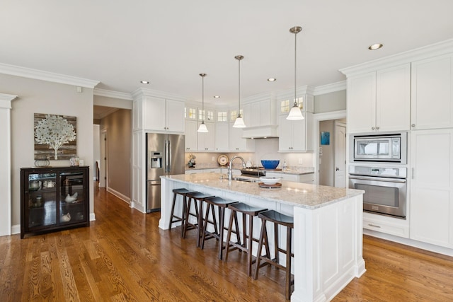 1731 Hudson Rd, Madison, TN 37115 - kitchen with stainless steel appliances, white cabinets, a breakfast bar area, recessed lighting, and decorative light fixtures