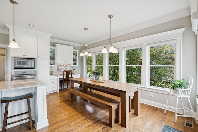 1731 Hudson Rd, Madison, TN 37115 - dining area with healthy amount of natural light, light wood-style flooring, and crown molding
