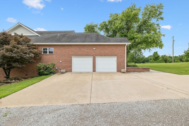 1731 Hudson Rd, Madison, TN 37115 - view of property exterior featuring concrete driveway, brick siding, an attached garage, and roof with shingles