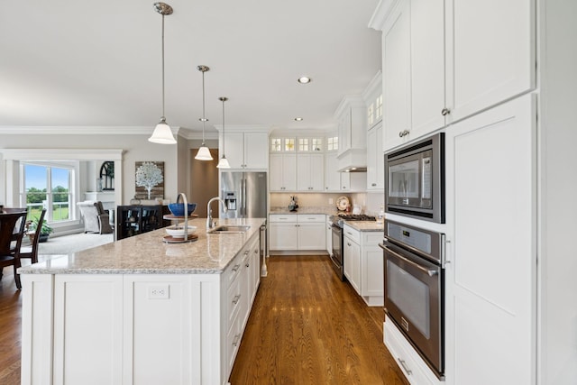 1731 Hudson Rd, Madison, TN 37115 - kitchen featuring appliances with stainless steel finishes, dark wood-style floors, white cabinets, ornamental molding, and glass insert cabinets