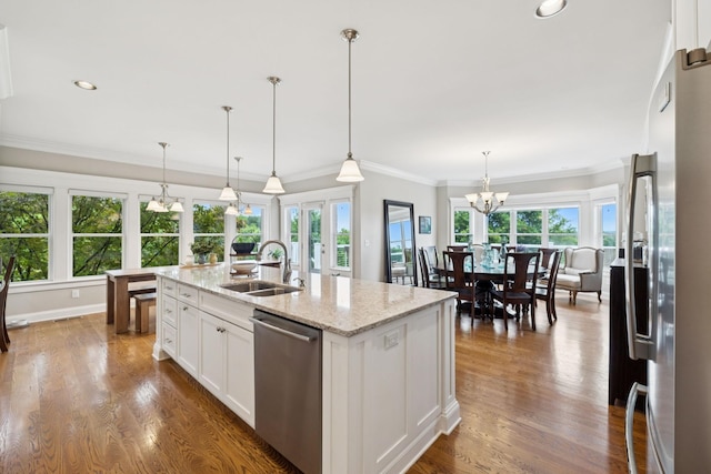 1731 Hudson Rd, Madison, TN 37115 - kitchen with stainless steel appliances, a chandelier, healthy amount of natural light, white cabinetry, and ornamental molding