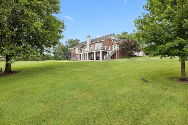 1731 Hudson Rd, Madison, TN 37115 - view of green lawn with stairway, a wooden deck, and a trampoline