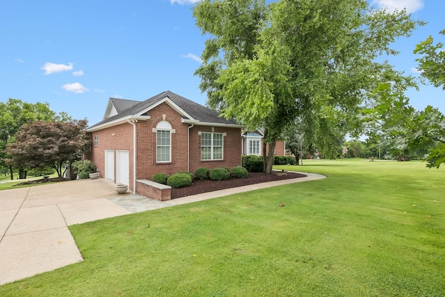 1731 Hudson Rd, Madison, TN 37115 - view of property exterior featuring driveway, brick siding, and a lawn