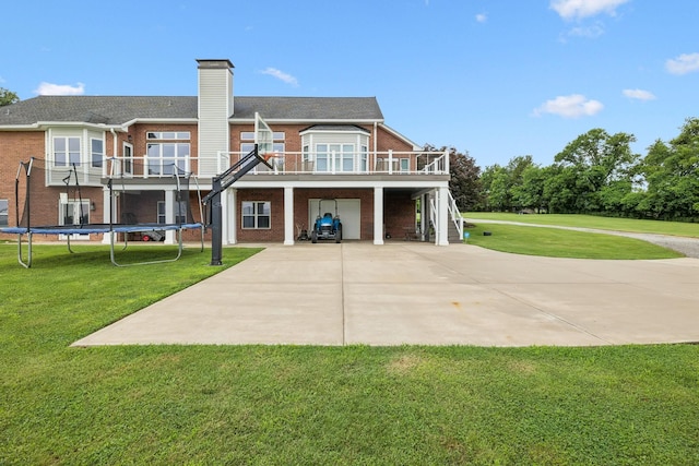 1731 Hudson Rd, Madison, TN 37115 - back of house with brick siding, a carport, concrete driveway, and a yard