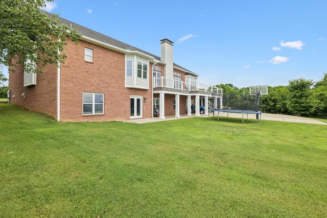 1731 Hudson Rd, Madison, TN 37115 - rear view of property with a chimney, a trampoline, a lawn, and a patio