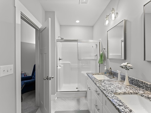 506 Bill Fuson Rd, Mcminnville, TN 37110 - ensuite bathroom featuring a stall shower, double vanity, recessed lighting, and tile patterned flooring