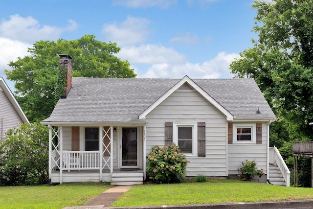 1803 Dimple Ct, Columbia, TN 38401 - view of front facade featuring covered porch, a shingled roof, a front yard, and a chimney
