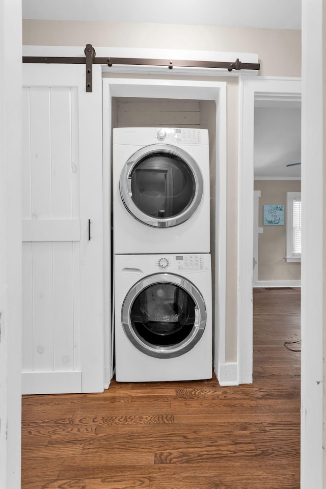 1803 Dimple Ct, Columbia, TN 38401 - washroom with estacked washer and dryer, wood finished floors, a barn door, and ornamental molding