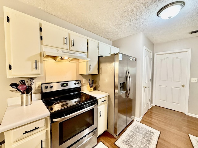 1252 Azure Way, Murfreesboro, TN 37128 - kitchen featuring stainless steel appliances, under cabinet range hood, light wood-style floors, light countertops, and a textured ceiling