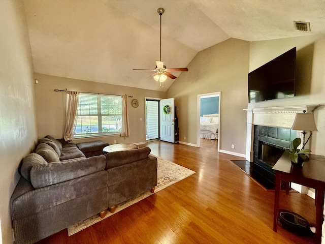 1252 Azure Way, Murfreesboro, TN 37128 - living room featuring wood finished floors, ceiling fan, a tiled fireplace, and high vaulted ceiling