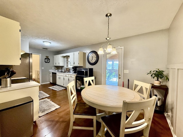 1252 Azure Way, Murfreesboro, TN 37128 - dining room featuring dark wood-style flooring, a textured ceiling, and a chandelier