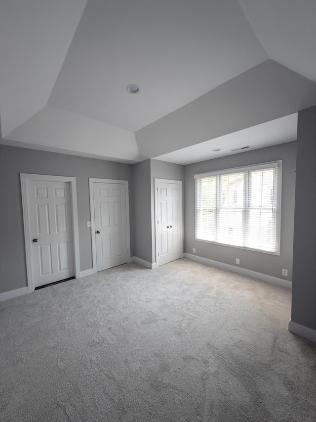 527 32nd Ave S, Nashville, TN 37212 - unfurnished bedroom with carpet flooring, a raised ceiling, and two closets