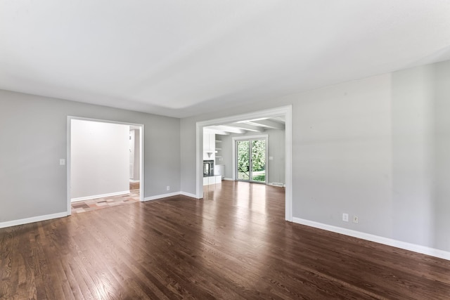1006 Houston Dr, Murfreesboro, TN 37130 - unfurnished living room with dark wood-style floors and baseboards