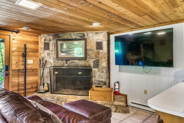 1530 Zurich Rd, Gatlinburg, TN 37738 - living area with baseboard heating, tile patterned floors, wood ceiling, a fireplace, and wooden walls