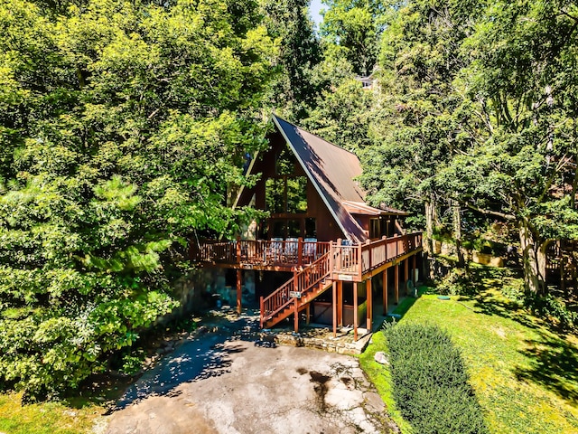 1530 Zurich Rd, Gatlinburg, TN 37738 - view of front facade with a wooden deck, stairway, and a view of trees