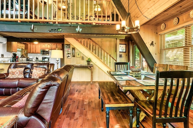 1530 Zurich Rd, Gatlinburg, TN 37738 - dining space featuring wood finished floors, a wall mounted AC, a chandelier, stairway, and wood ceiling