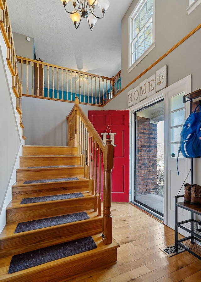 783 W Main St, Mcminnville, TN 37110 - staircase featuring a chandelier, wood-type flooring, and a towering ceiling