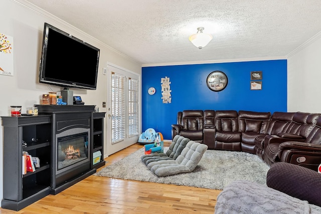 783 W Main St, Mcminnville, TN 37110 - living room featuring ornamental molding, wood finished floors, a glass covered fireplace, and a textured ceiling