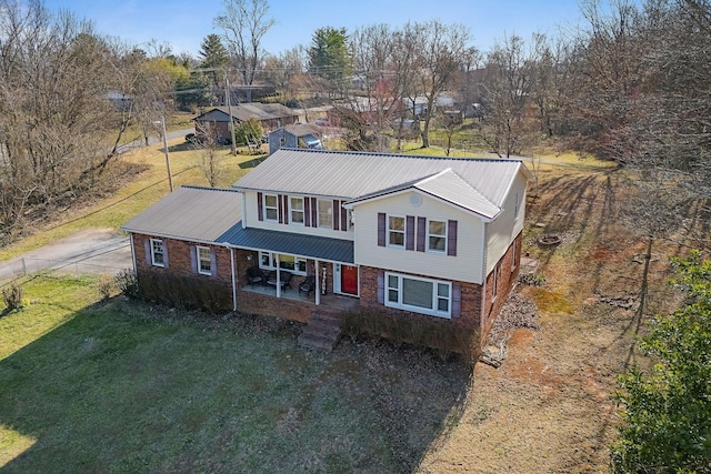 783 W Main St, Mcminnville, TN 37110 - traditional home with a front yard, covered porch, a metal roof, and brick siding