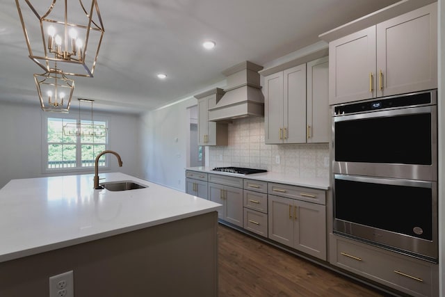 19 Peyton Pl, Columbia, TN 38401 - kitchen featuring appliances with stainless steel finishes, a chandelier, premium range hood, dark wood-type flooring, and backsplash