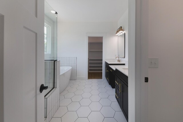 19 Peyton Pl, Columbia, TN 38401 - full bath featuring double vanity, a freestanding bath, tile patterned flooring, and a spacious closet
