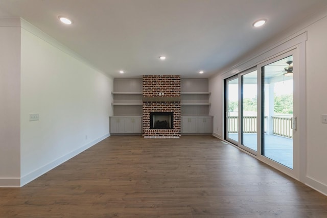 19 Peyton Pl, Columbia, TN 38401 - unfurnished living room with dark wood finished floors, recessed lighting, a brick fireplace, and built in features
