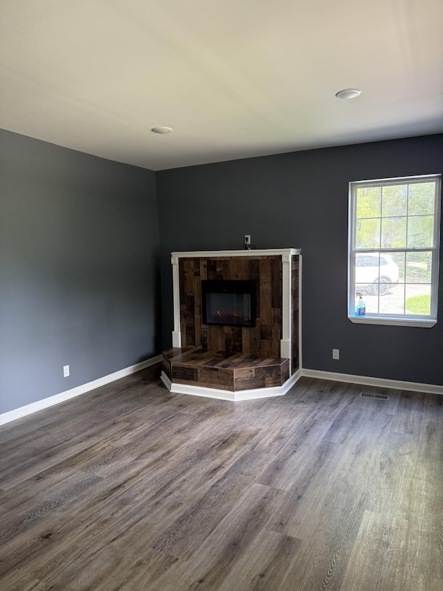 975 Witcher Hollow Rd, Red Boiling Springs, TN 37150 - unfurnished living room featuring wood finished floors and a tiled fireplace