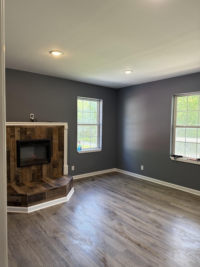 975 Witcher Hollow Rd, Red Boiling Springs, TN 37150 - unfurnished living room with wood finished floors, recessed lighting, and a fireplace with raised hearth