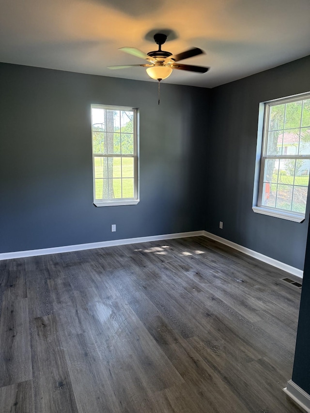975 Witcher Hollow Rd, Red Boiling Springs, TN 37150 - unfurnished room with healthy amount of natural light, ceiling fan, and dark wood-style flooring