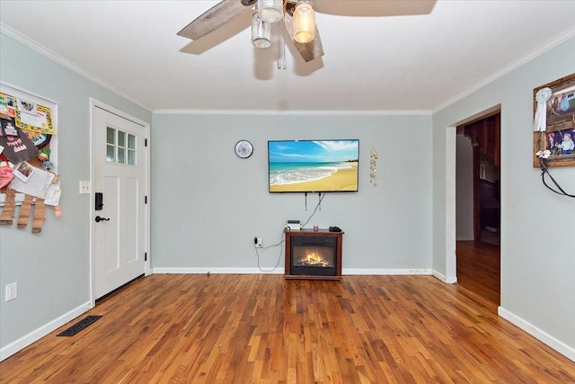135 Campbellsville Pike, Ethridge, TN 38456 - unfurnished living room with ornamental molding, wood finished floors, a ceiling fan, and a lit fireplace