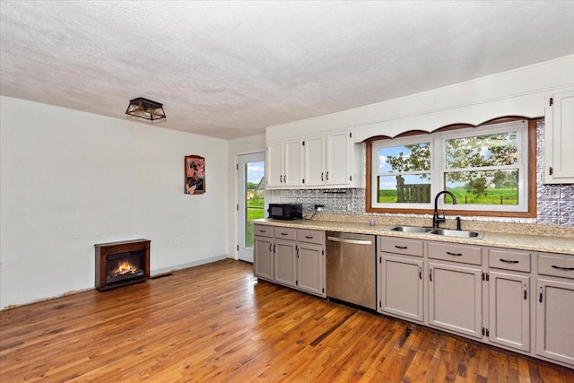 135 Campbellsville Pike, Ethridge, TN 38456 - kitchen with dishwasher, backsplash, wood finished floors, light countertops, and a textured ceiling