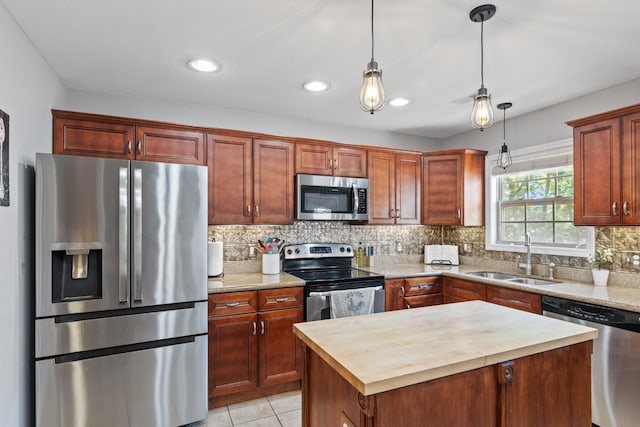 1386 Bruceton Dr, Clarksville, TN 37042 - kitchen featuring appliances with stainless steel finishes, butcher block counters, tasteful backsplash, pendant lighting, and a kitchen island