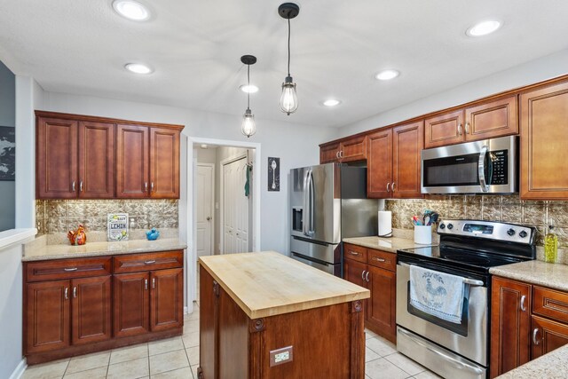 1386 Bruceton Dr, Clarksville, TN 37042 - kitchen with appliances with stainless steel finishes, butcher block counters, light tile patterned flooring, tasteful backsplash, and recessed lighting