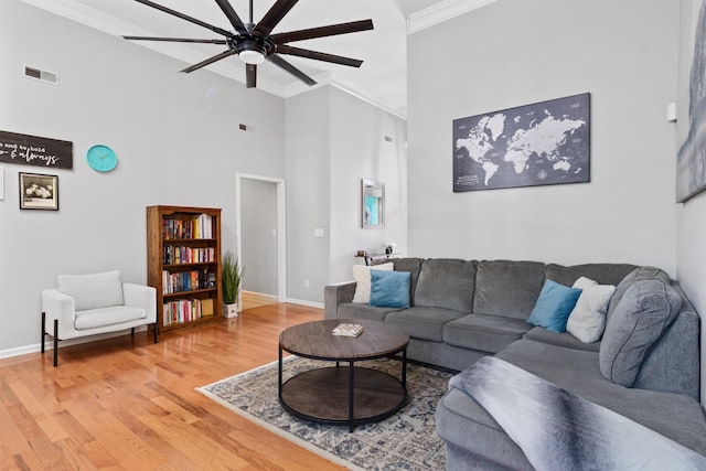 1386 Bruceton Dr, Clarksville, TN 37042 - living area featuring ornamental molding, a high ceiling, a ceiling fan, and light wood-type flooring
