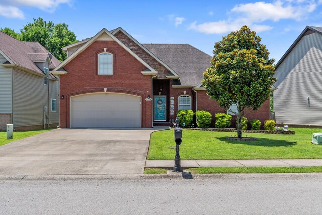 1386 Bruceton Dr, Clarksville, TN 37042 - traditional-style home featuring brick siding, a garage, driveway, a front yard, and a shingled roof