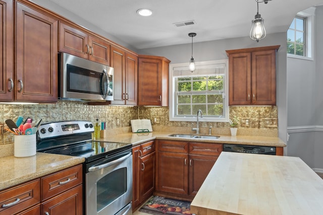 1386 Bruceton Dr, Clarksville, TN 37042 - kitchen featuring appliances with stainless steel finishes, pendant lighting, wooden counters, and backsplash