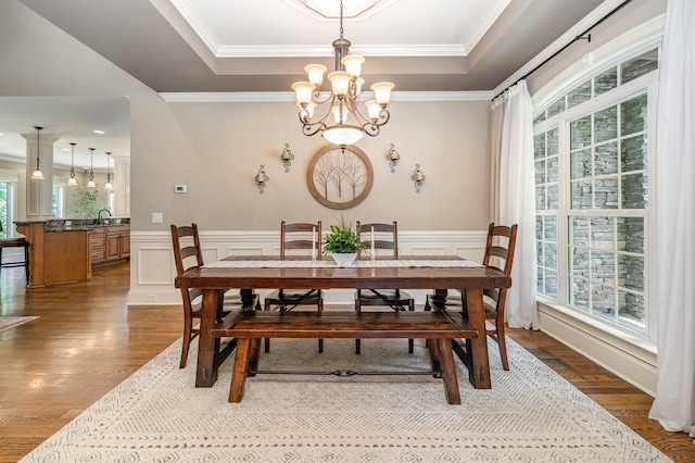517 Burnett Rd, Mount Juliet, TN 37122 - dining space featuring a tray ceiling, wood finished floors, a chandelier, ornamental molding, and a decorative wall