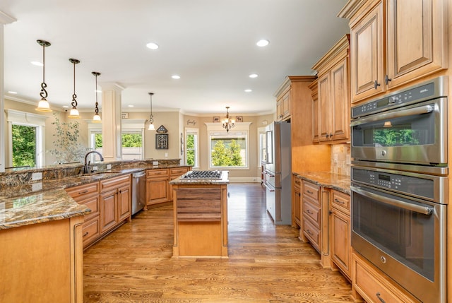 517 Burnett Rd, Mount Juliet, TN 37122 - kitchen with stainless steel appliances, a large island, ornamental molding, light wood finished floors, and recessed lighting