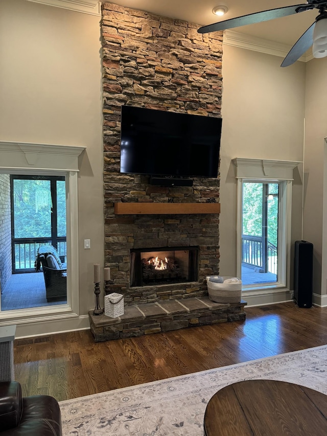 517 Burnett Rd, Mount Juliet, TN 37122 - living room with ornamental molding, wood finished floors, a stone fireplace, ceiling fan, and plenty of natural light