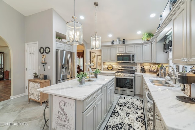 187 Forest View Dr, Crossville, TN 38558 - kitchen with appliances with stainless steel finishes, arched walkways, tasteful backsplash, a kitchen island, and recessed lighting