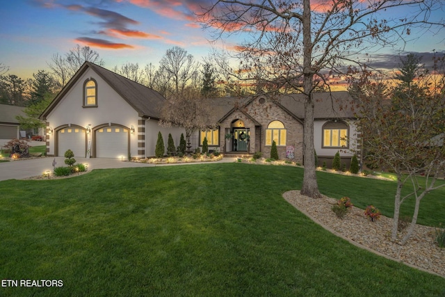 187 Forest View Dr, Crossville, TN 38558 - view of front facade with stucco siding, a yard, driveway, a garage, and stone siding