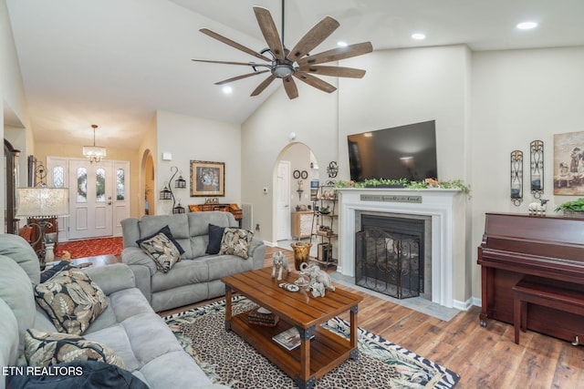 187 Forest View Dr, Crossville, TN 38558 - living area featuring arched walkways, high vaulted ceiling, ceiling fan, wood finished floors, and a fireplace with flush hearth