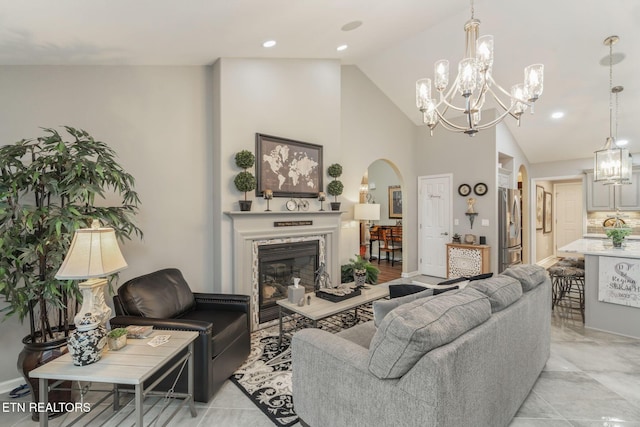 187 Forest View Dr, Crossville, TN 38558 - living area featuring a chandelier, arched walkways, lofted ceiling, a fireplace, and recessed lighting