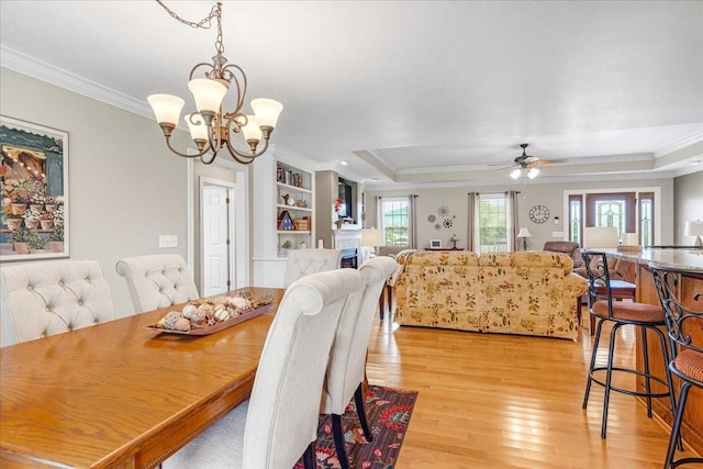 379 Hooper Rd, Winchester, TN 37398 - dining space featuring crown molding, light wood-style floors, a tray ceiling, a chandelier, and ceiling fan